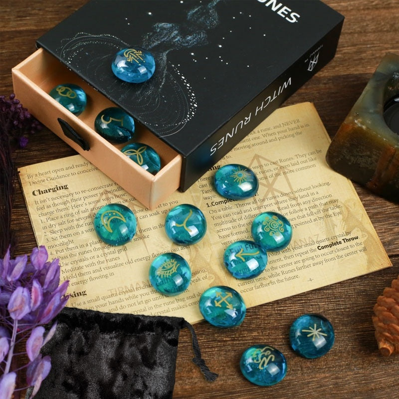 Blue mystical stones with star designs on a wooden surface next to a box labeled 'Witch Runes'.
