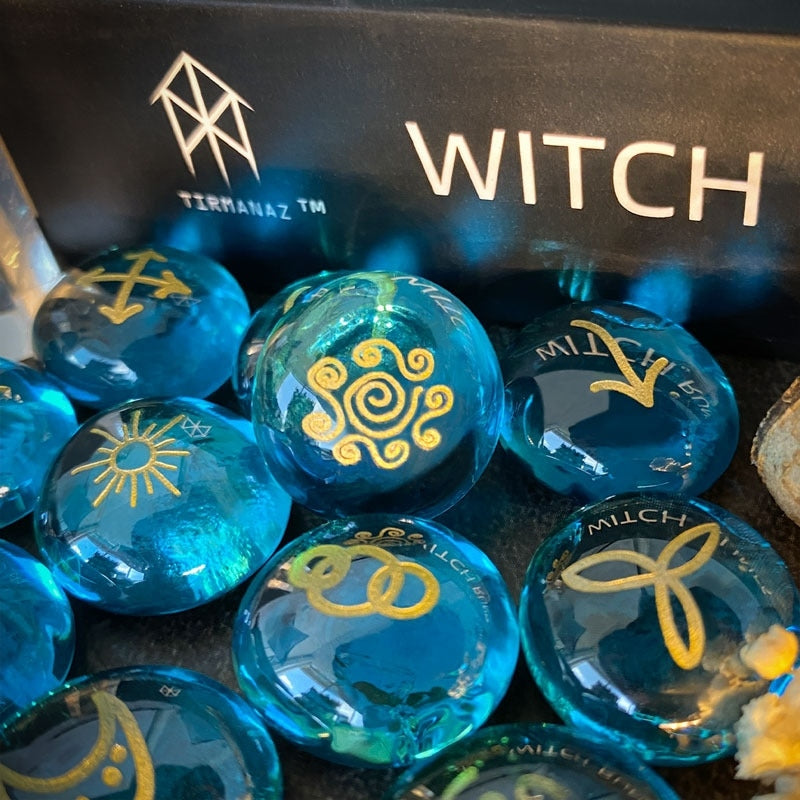 Blue rune stones with gold symbols in front of a black box labeled 'WITCH' by Tirmanaz.