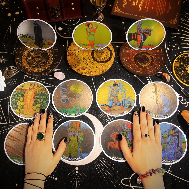 Round Gold Foil Tarot cards on a starry background with hands and rings.