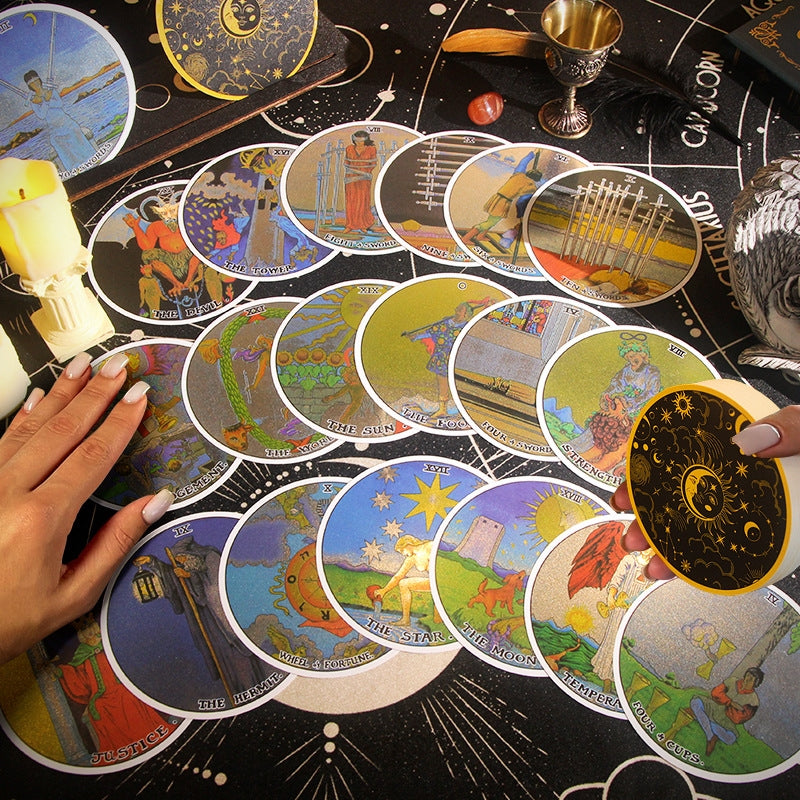 Collection of Circular Gold Foil tarot cards on a tarot table with hands touching the cards.