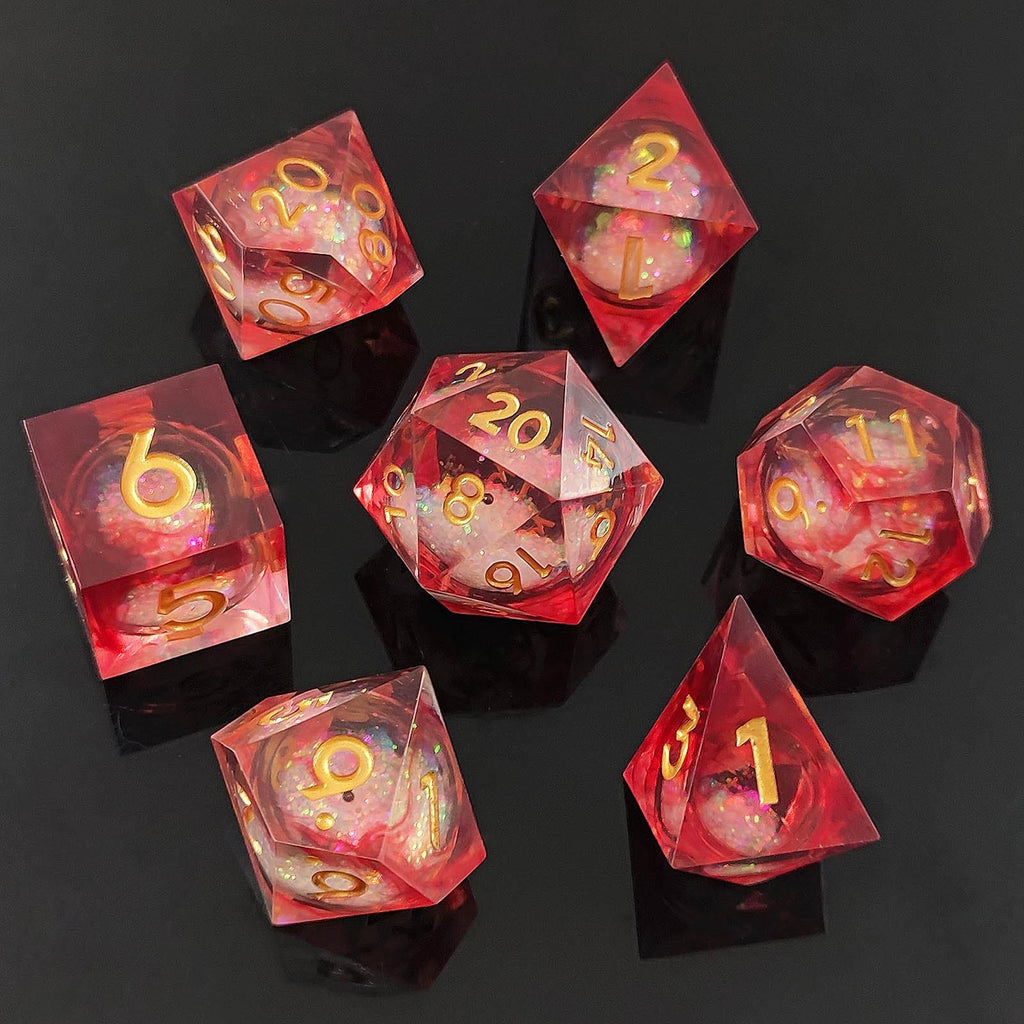 Set of red resin liquid core dice with gold foil numbers on a black background