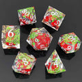 Set of colorful botanical resin liquid sand core dice with red, green, and clear faces on a black background