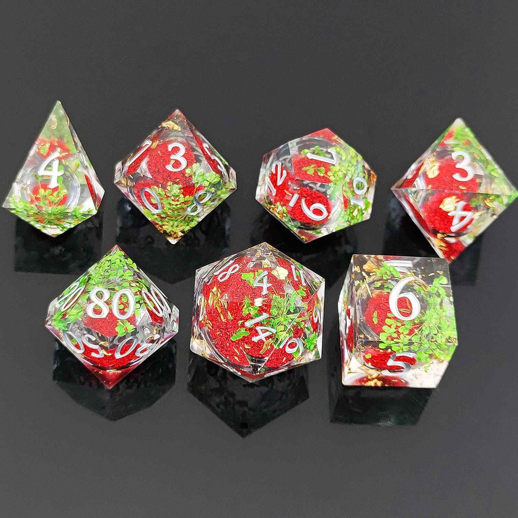 Set of colorful botanical resin liquid sand core dice with Christmas-themed design on a black background
