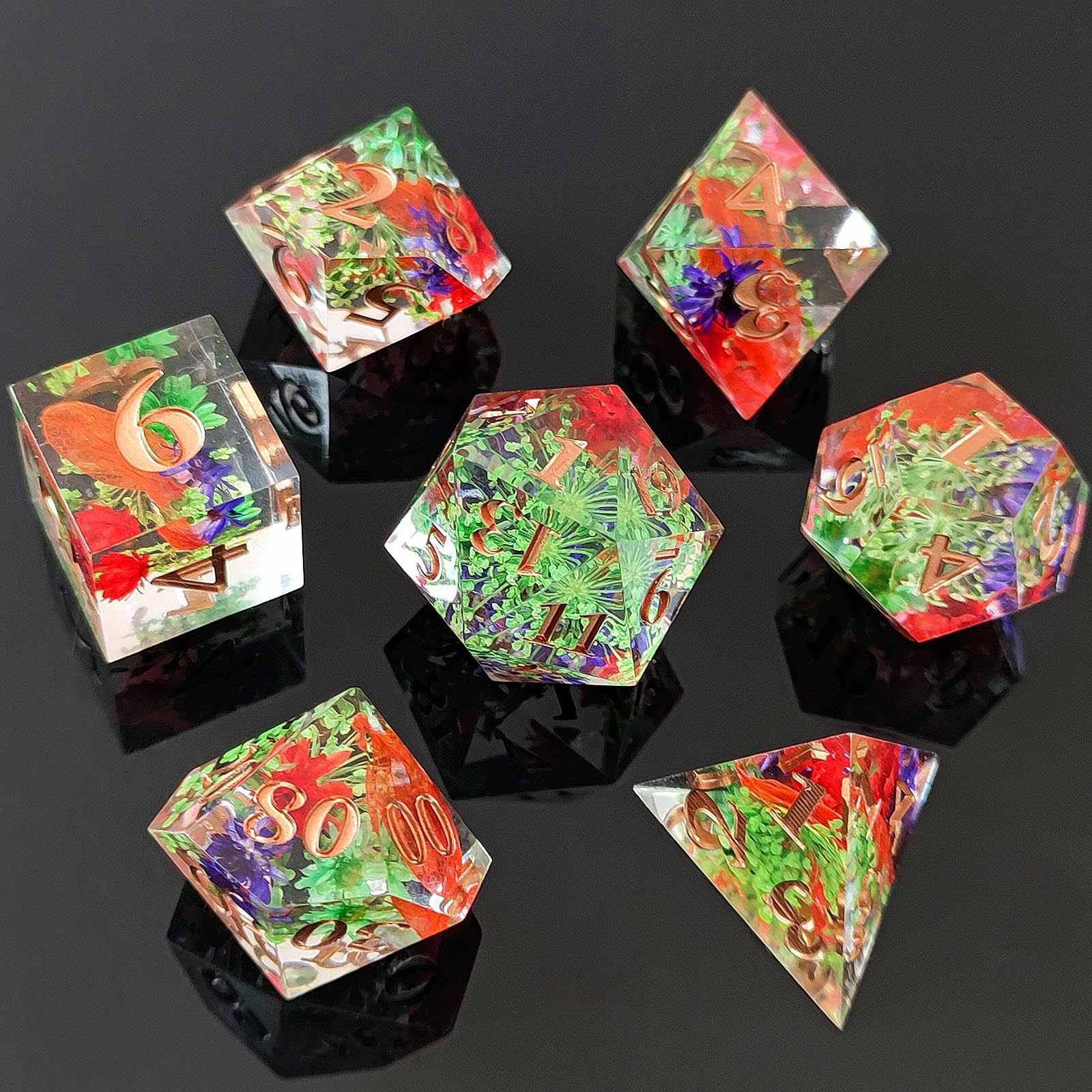 Set of colorful botanical resin polyhedral dice on a reflective black surface