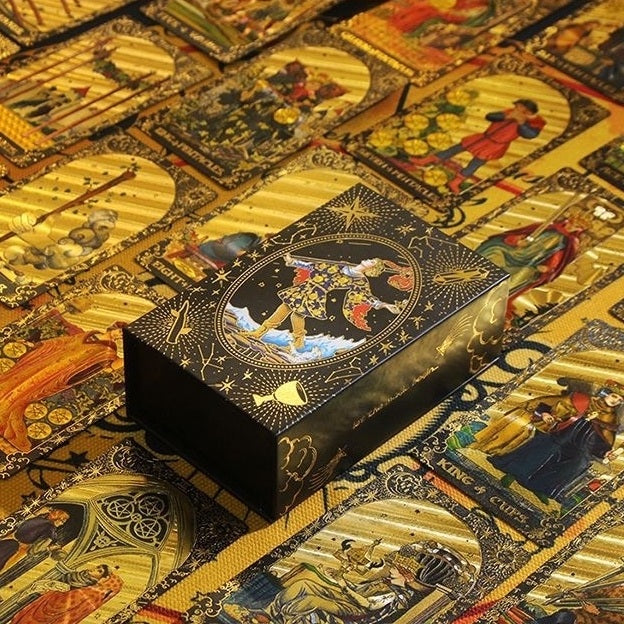Decorative box with intricate designs on a background of tarot cards