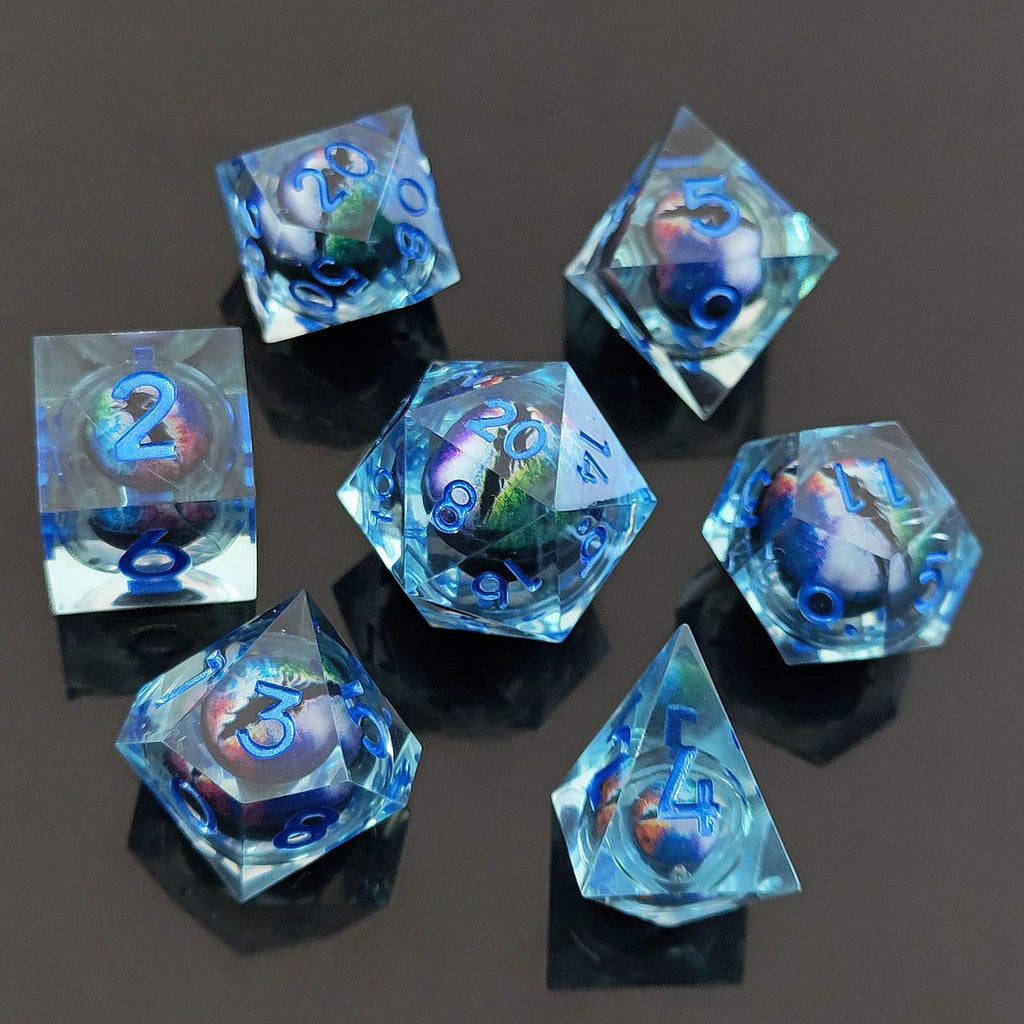 Set of blue transparent polyhedral dice with numbers on a dark surface