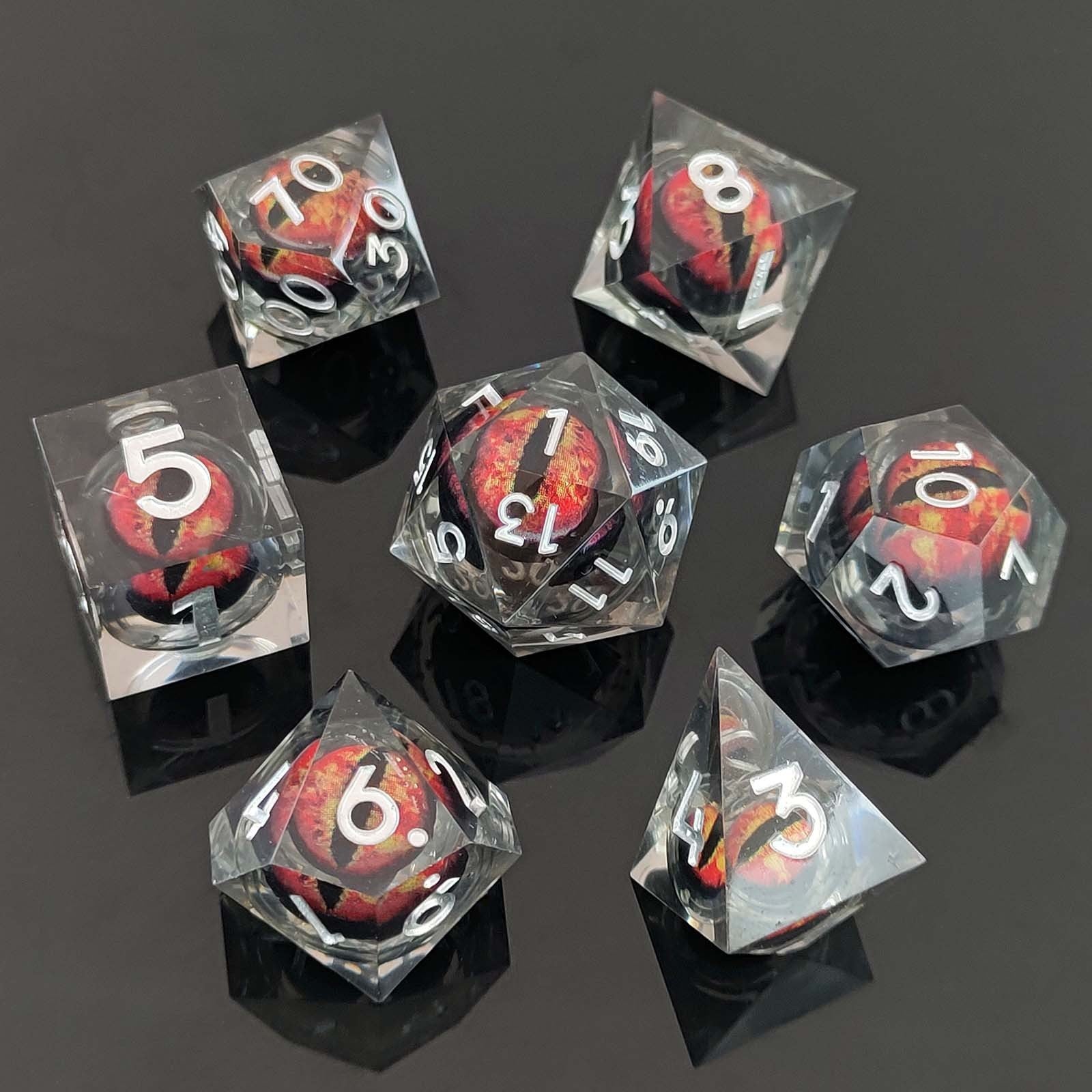 Set of transparent dice with red and black dragon eyes on a dark background