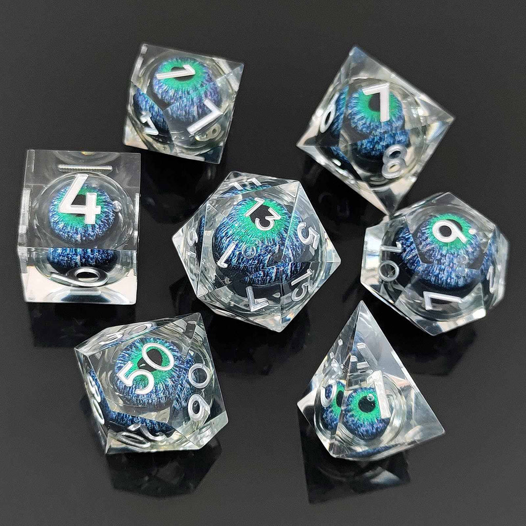 Set of clear Dragon Eye Liquid Core DND Dicewith blue and green numbers on a black background