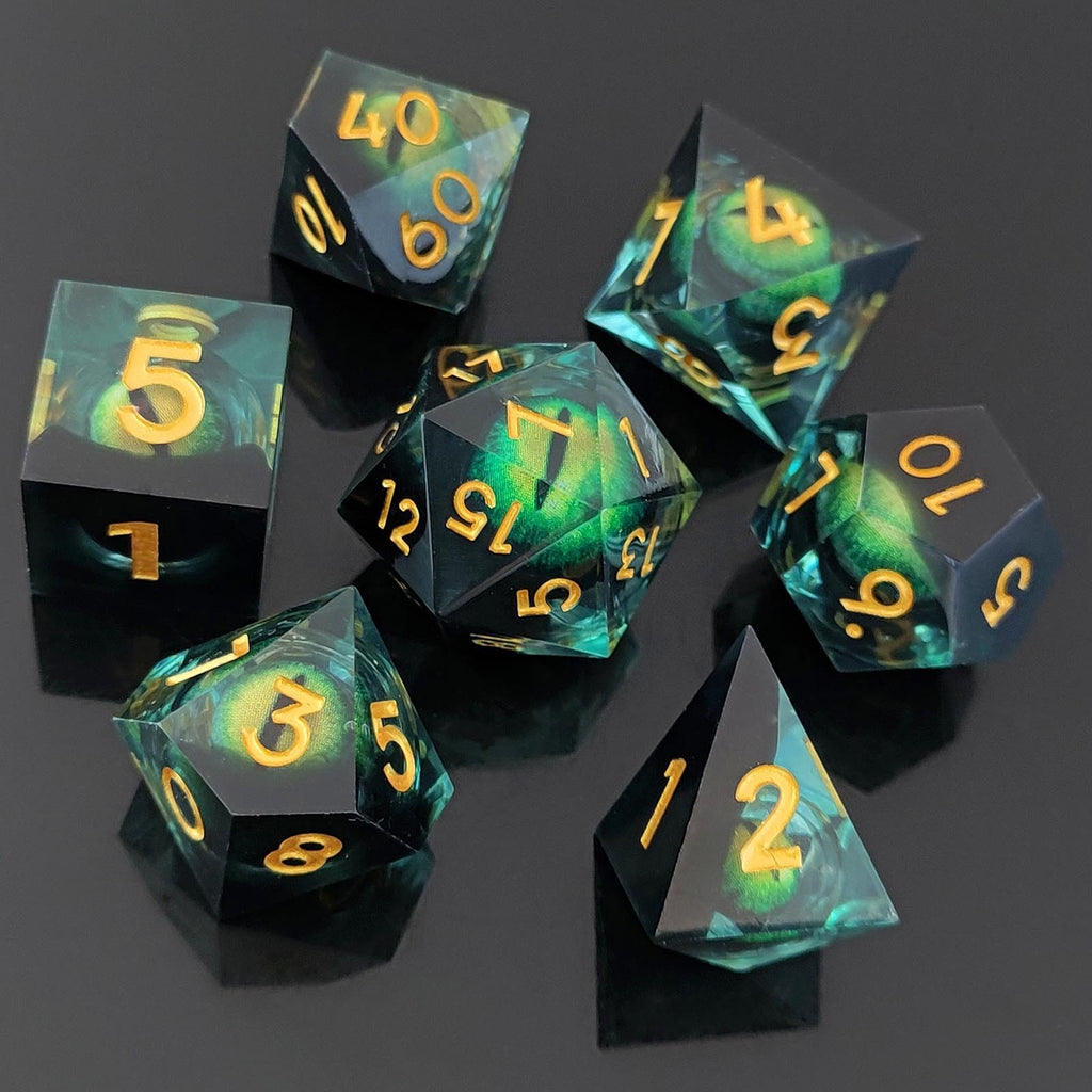Set of Dragon Eye Liquid Core DND Dicewith green and black colors and gold numbers on a dark background