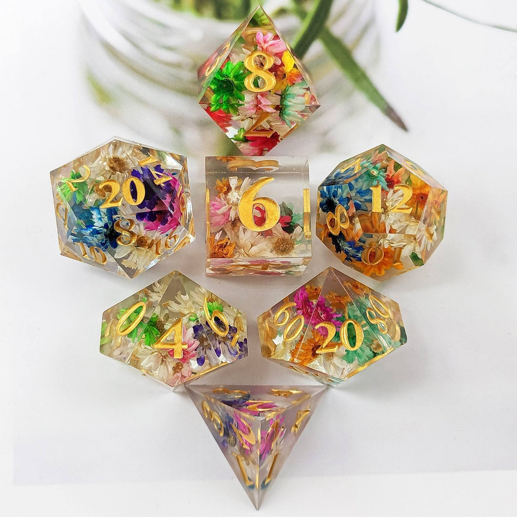 Set of colorful Sharp Edge Polyhedral resin dice with floral and natural elements on a white background