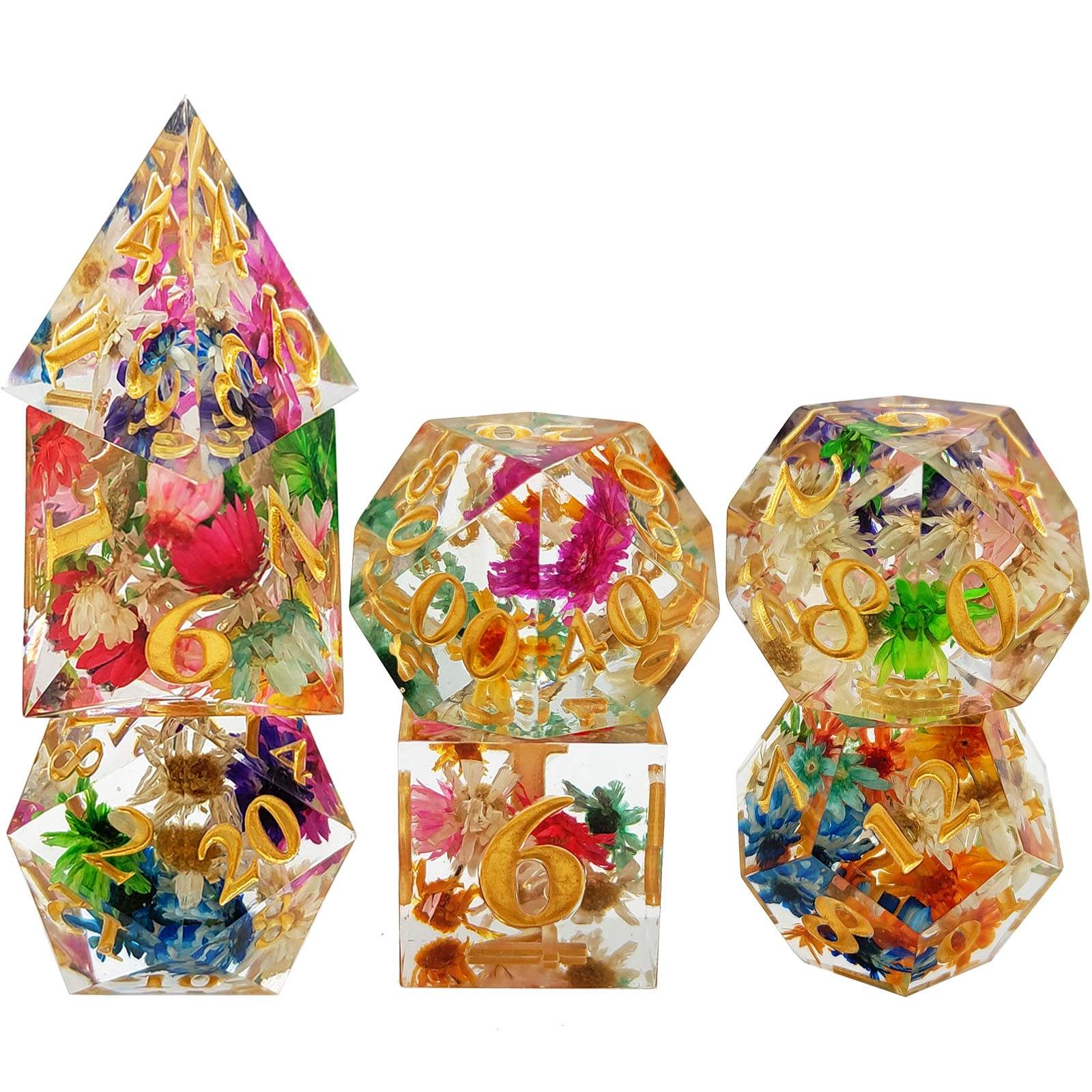 Set of transparent Sharp Edge Polyhedral resin dice with floral and number decorations on a white background