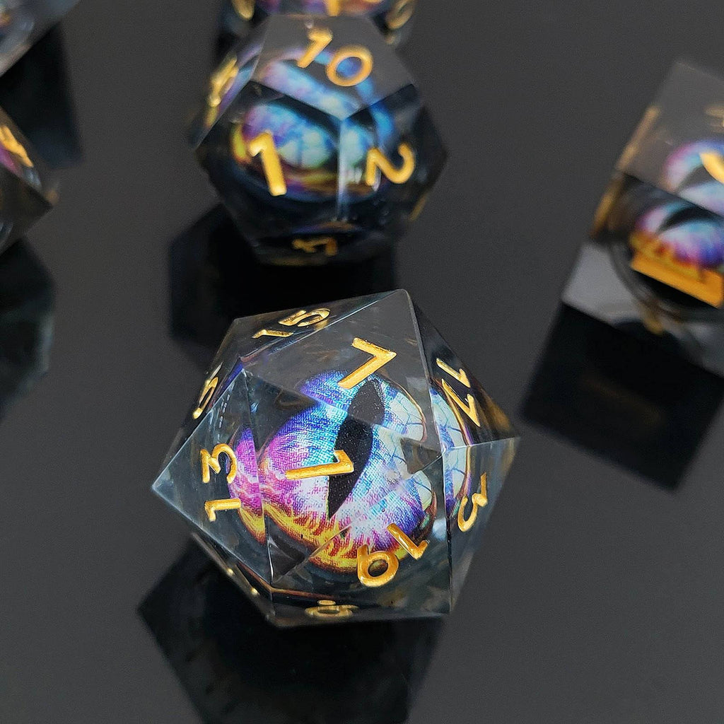 Close-up of a clear Floating Dragon Eye Liquid Core DND dice with colorful design and gold numbers on a dark background.