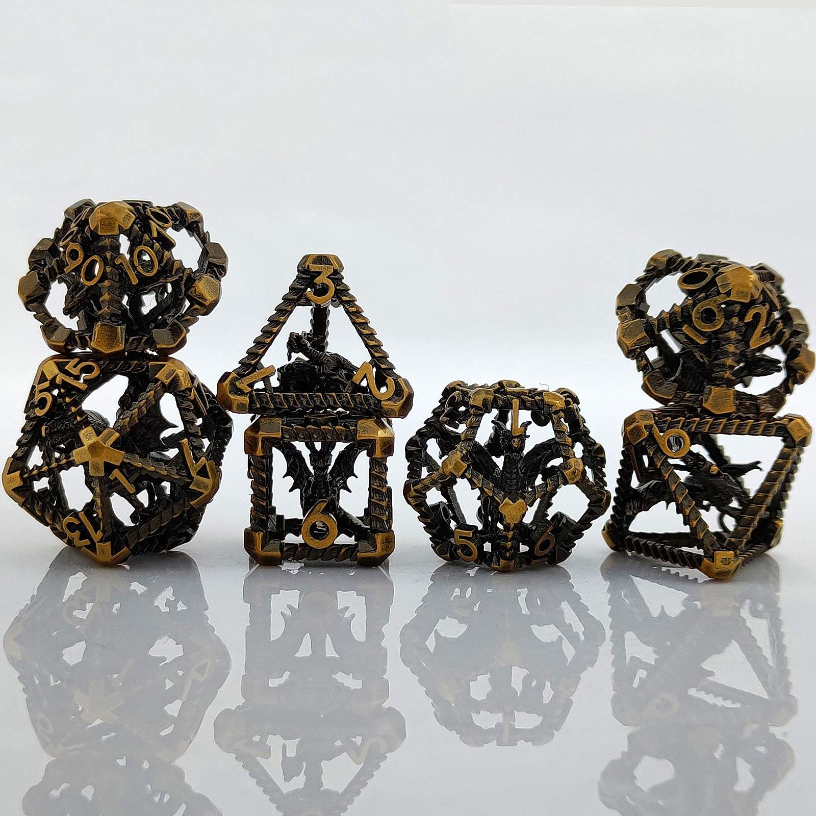 Set of four decorative metal Copper Polyhedral RPG dices on a reflective surface with a light gray background