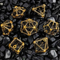 Gold Copper Polyhedral RPG dice set on black stone surface