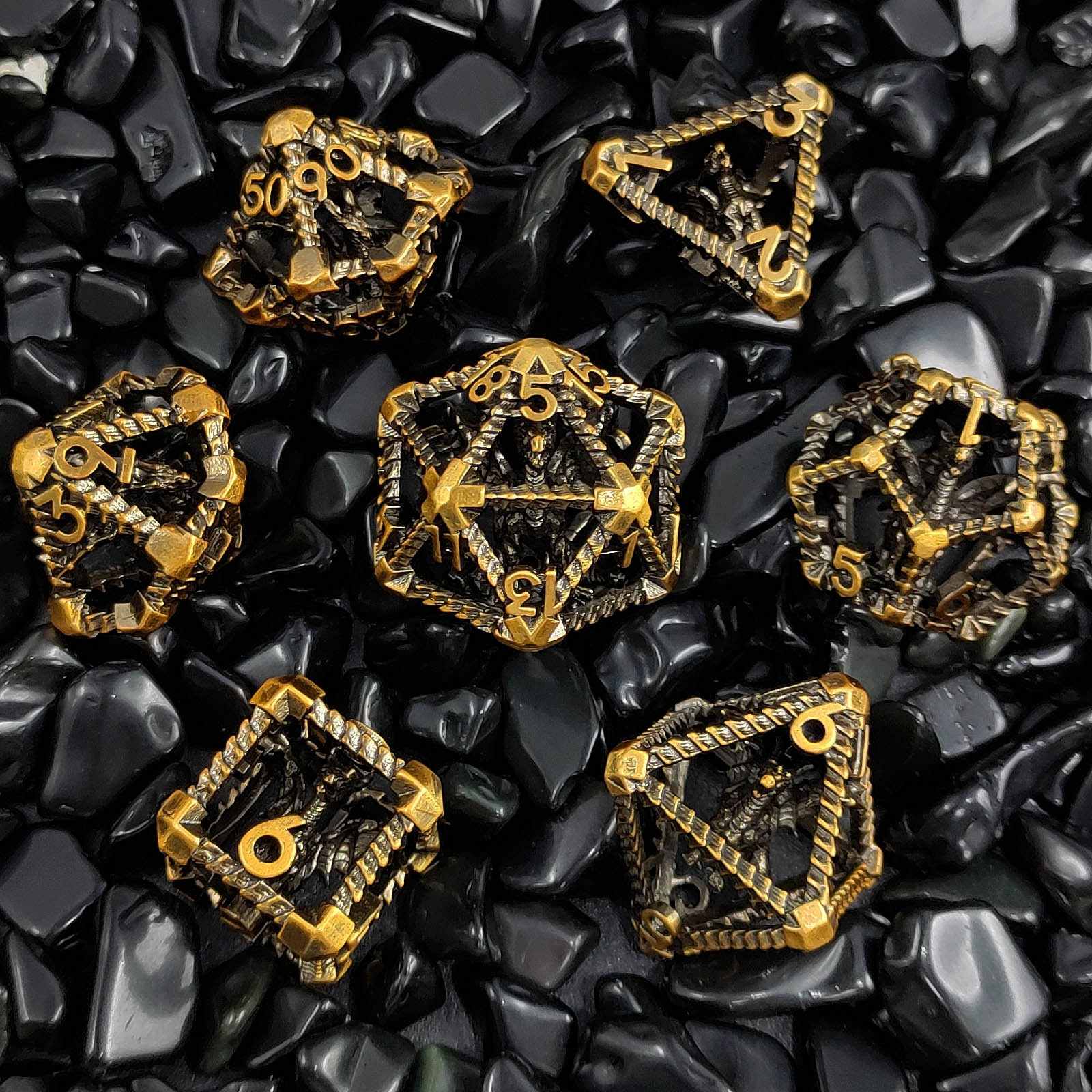 Gold Copper Polyhedral RPG dice set on black stone surface