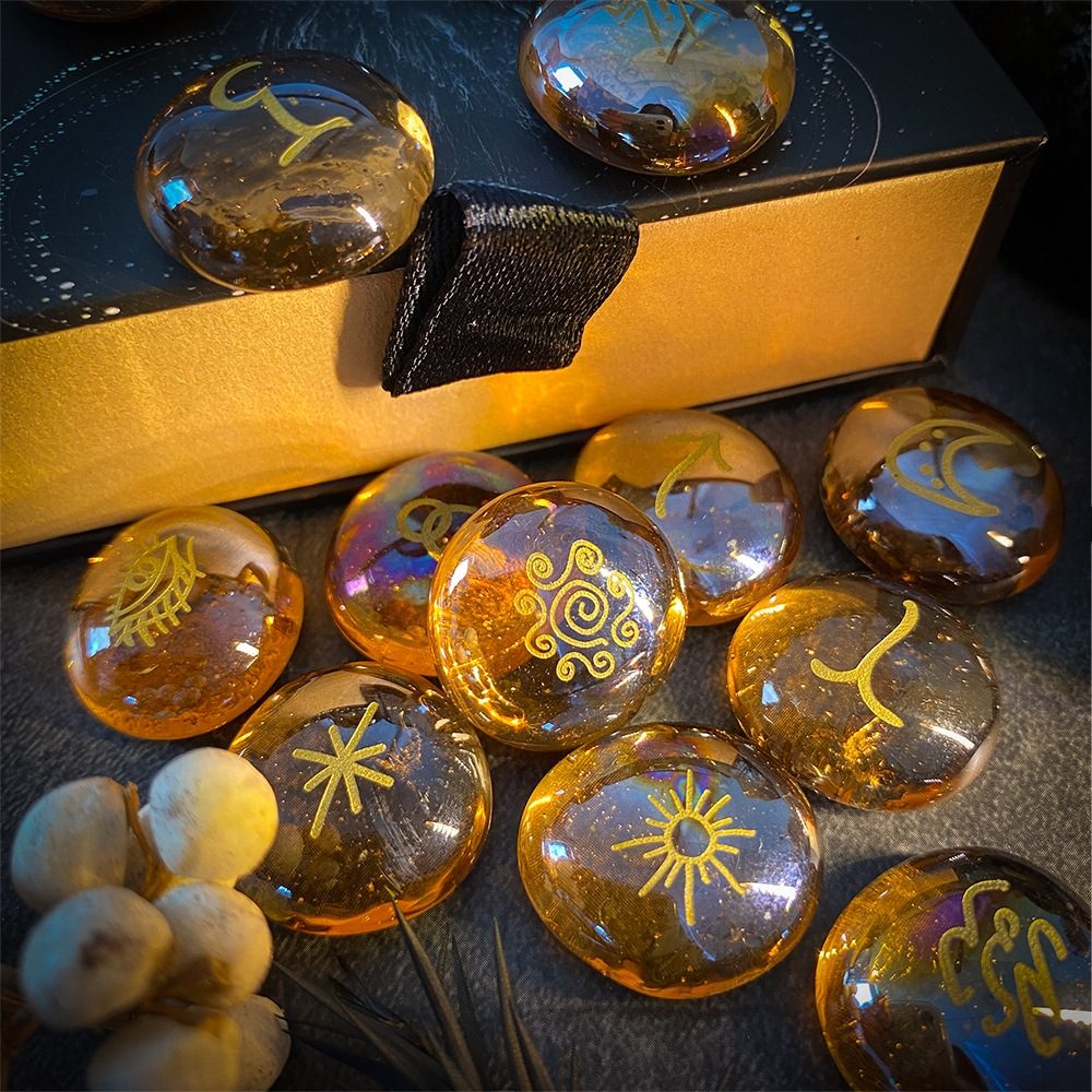 Set of amber-colored rune stones with engraved symbols on a dark surface.