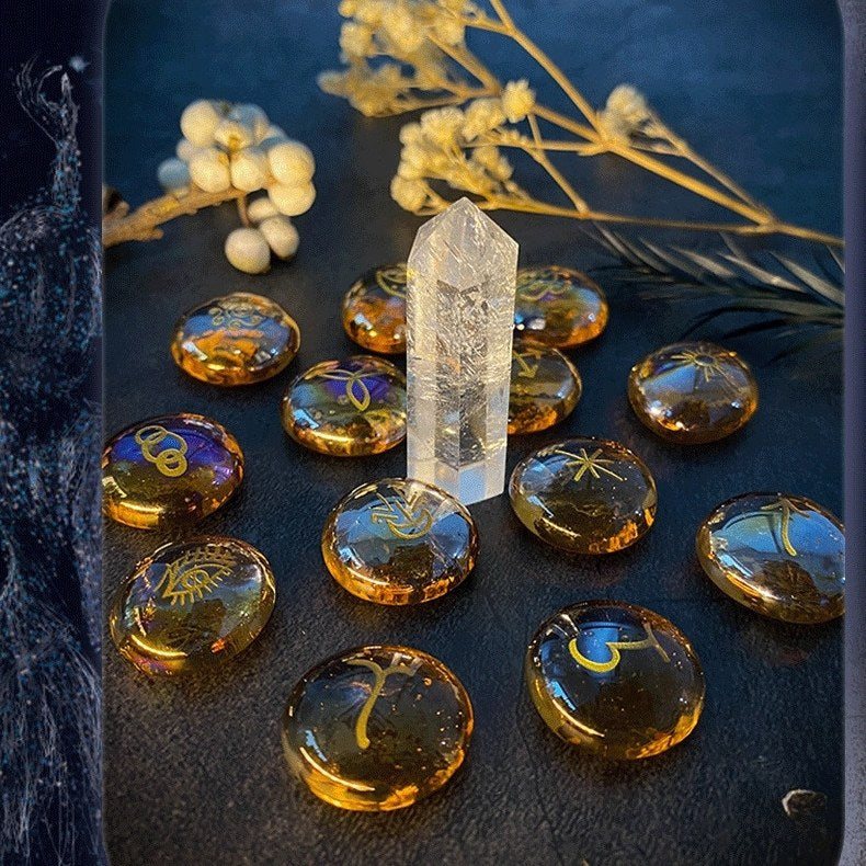 Crystal grid with amber-colored witch stones and a clear crystal on a dark surface.