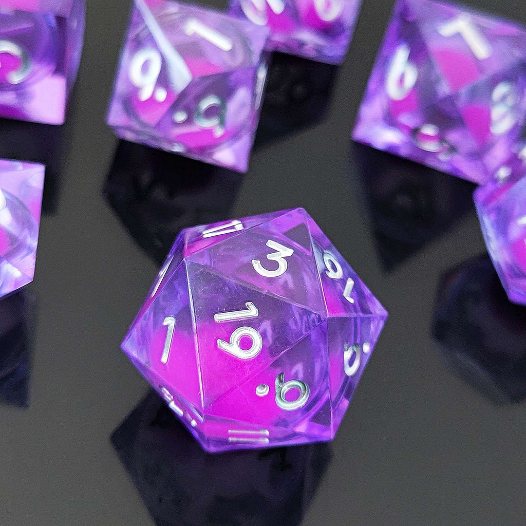 Purple polyhedral Glow-in-the-Dark Liquid Core dice with numbers on a reflective black surface
