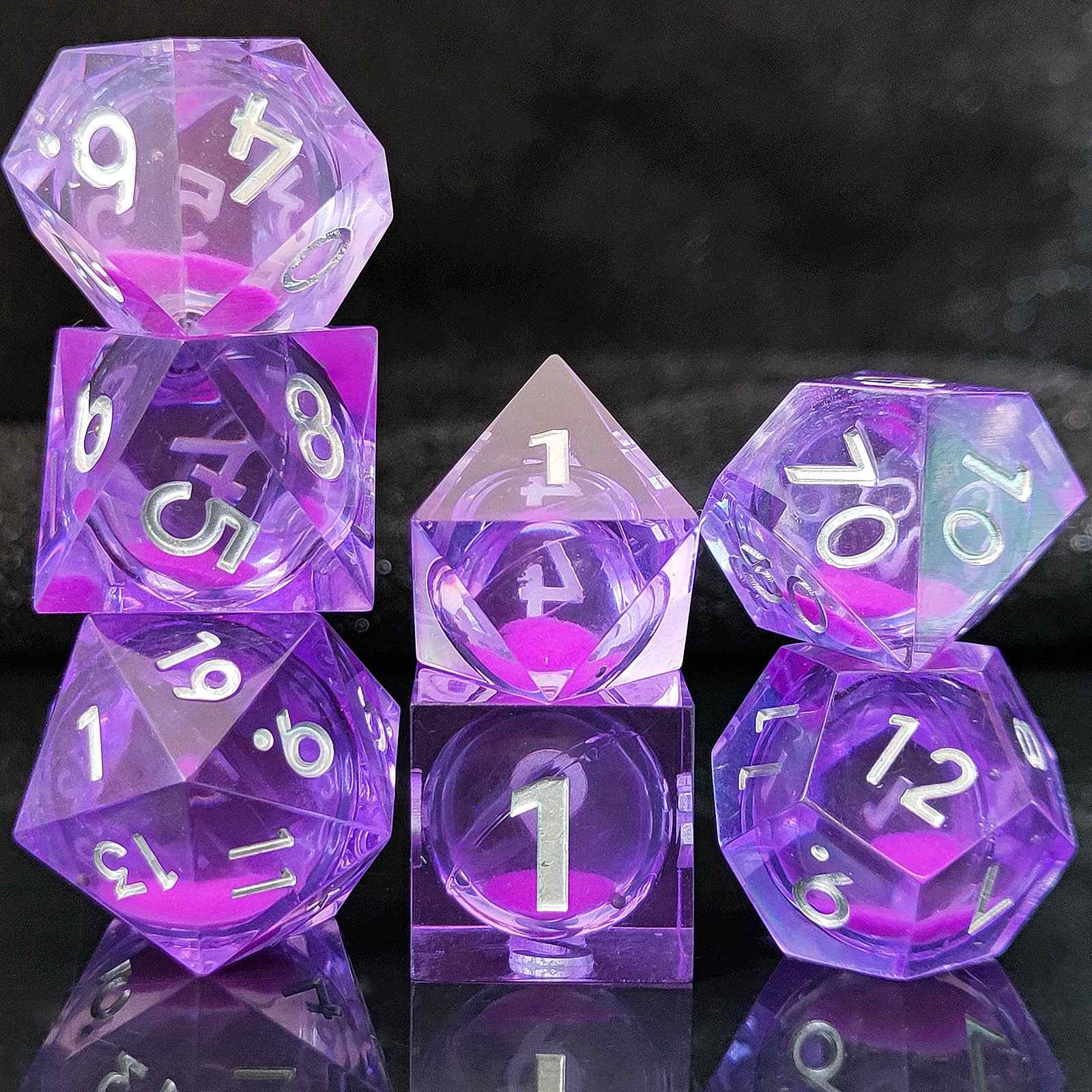 Set of purple polyhedral Glow-in-the-Dark Liquid Core dice with white numbers on a reflective surface.