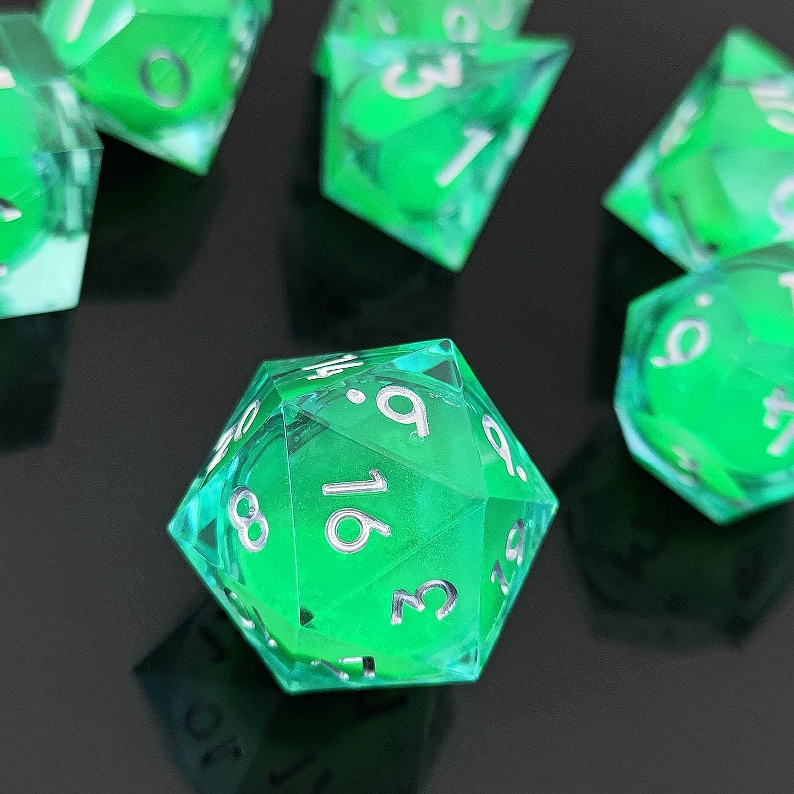 Green polyhedral Glow-in-the-Dark Liquid Core dice with white numbers on a black reflective surface