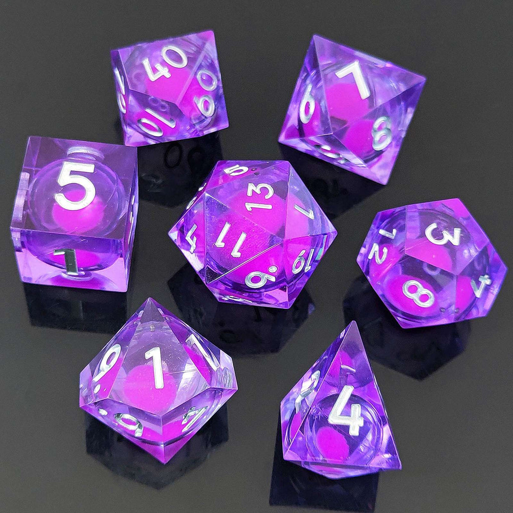 Set of purple polyhedral Glow-in-the-Dark Liquid Core dice with white numbers on a black background