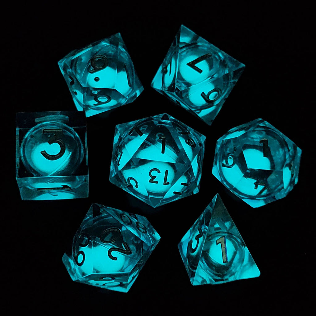 Set of glowing blue liquid core dice on a black background