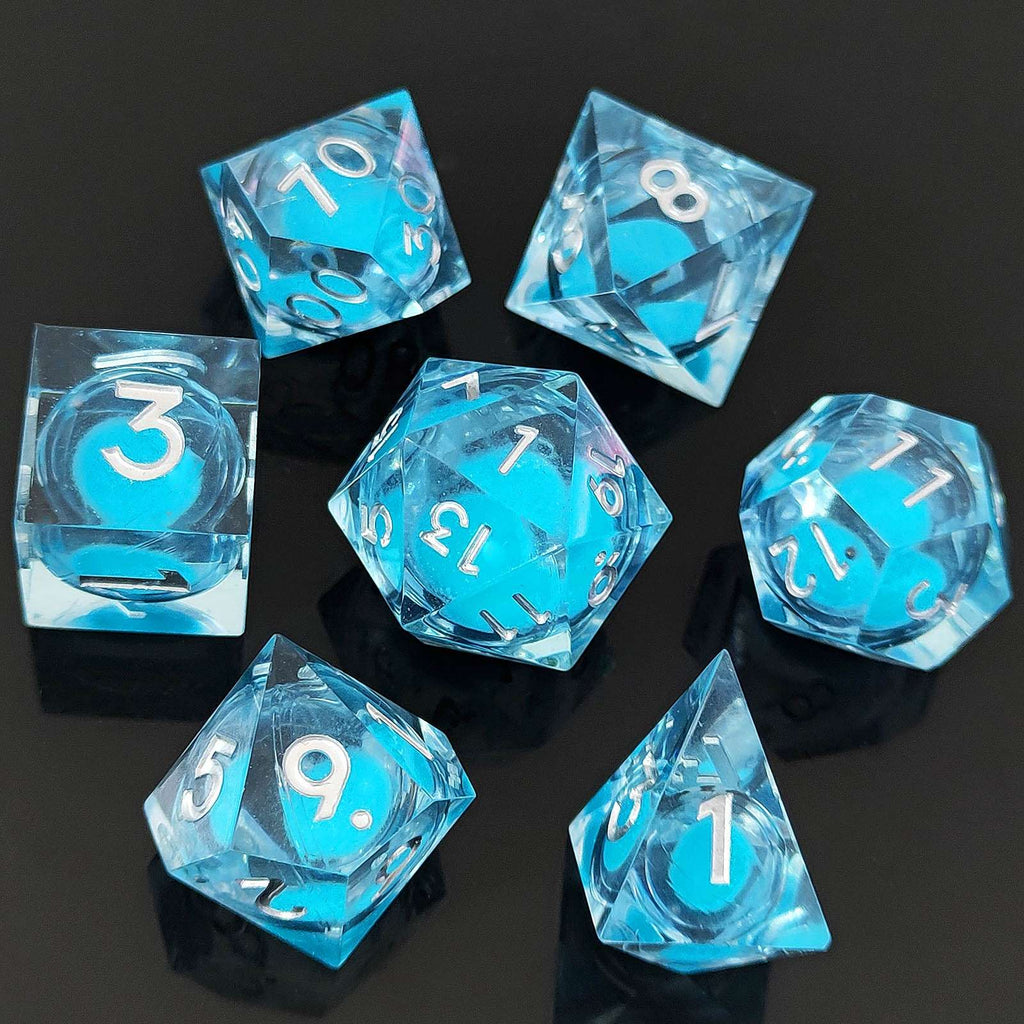 Set of blue transparent polyhedral Glow-in-the-Dark Liquid Core dice with white numbers on a black background