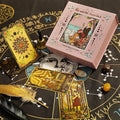 Rose Gold Foil Tarot cards, box and Chakra stones on a black astrological chart with decorative elements.