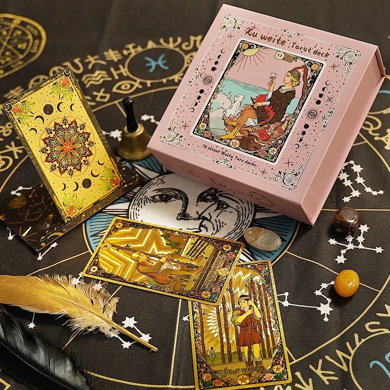 Rose Gold Foil Tarot cards, box and Chakra stones on a black astrological chart with decorative elements.