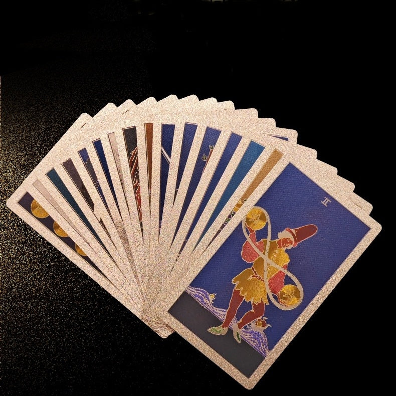Fanned-out gold foil tarot cards on a dark surface
