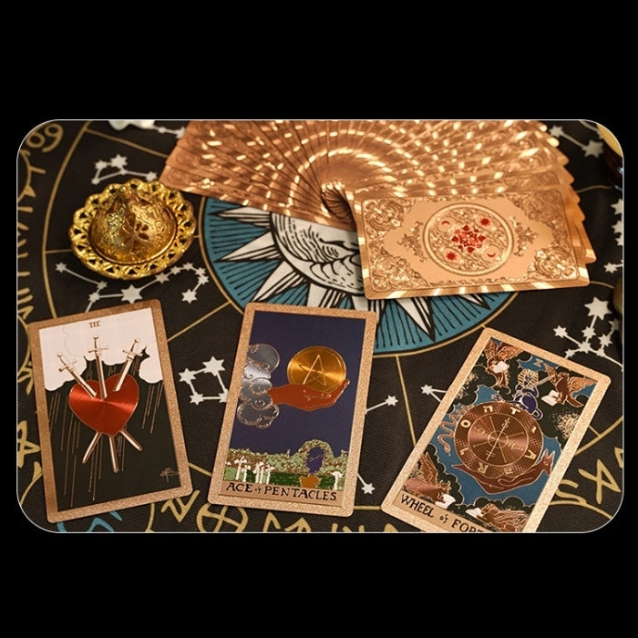 foil Tarot cards on a black background with star and moon designs
