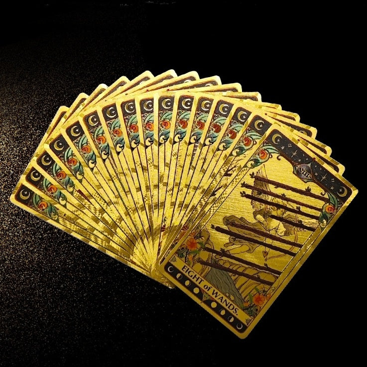 premium gold foil tarot cards fanned out on a dark surface