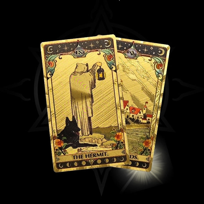 Twopremium gold foil tarot cards titled 'The Hermit' on a dark background