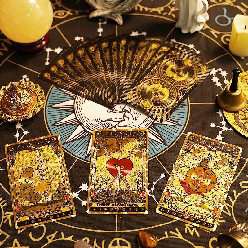 premium gold foil Tarot cards on a mystical table with candles and crystals