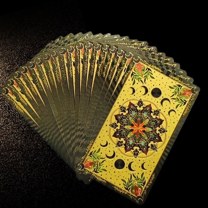 Fanned deck of Kaleidoscope Holographic Rainbow Foil tarot cards tarot cards with intricate designs on a black background