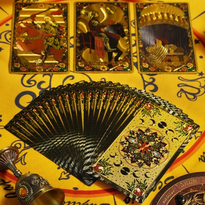 Fanned deck of Kaleidoscope Holographic Rainbow Foil tarot cards tarot cards on a decorative surface with intricate designs.