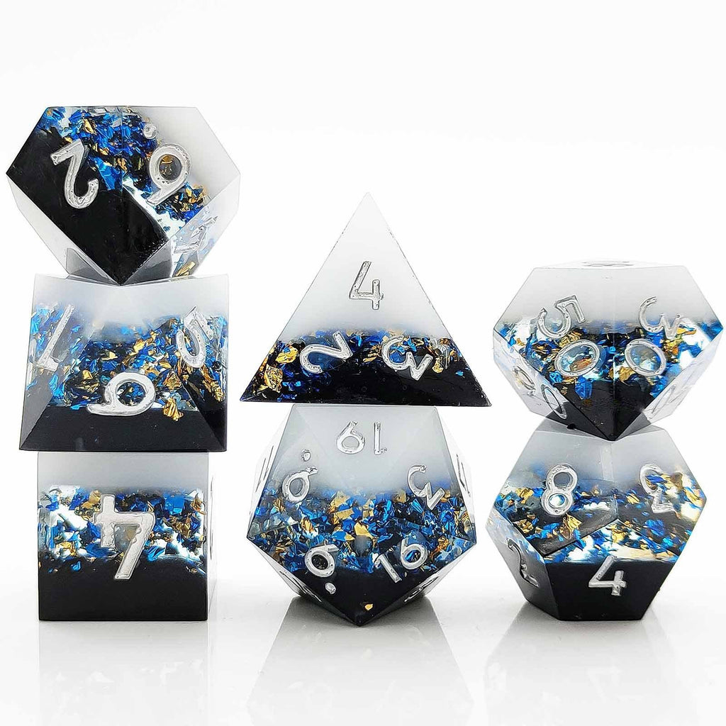 Set of  Liquid Core Resin dice with blue and gold embellishments on a white background