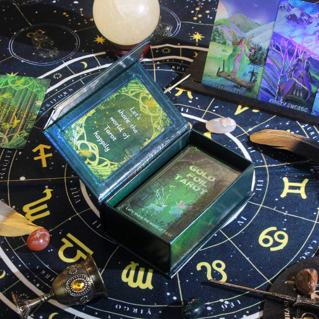Luxury magnetic-closure "Vault" box with gold foil detailing with green label on a tarot card spread