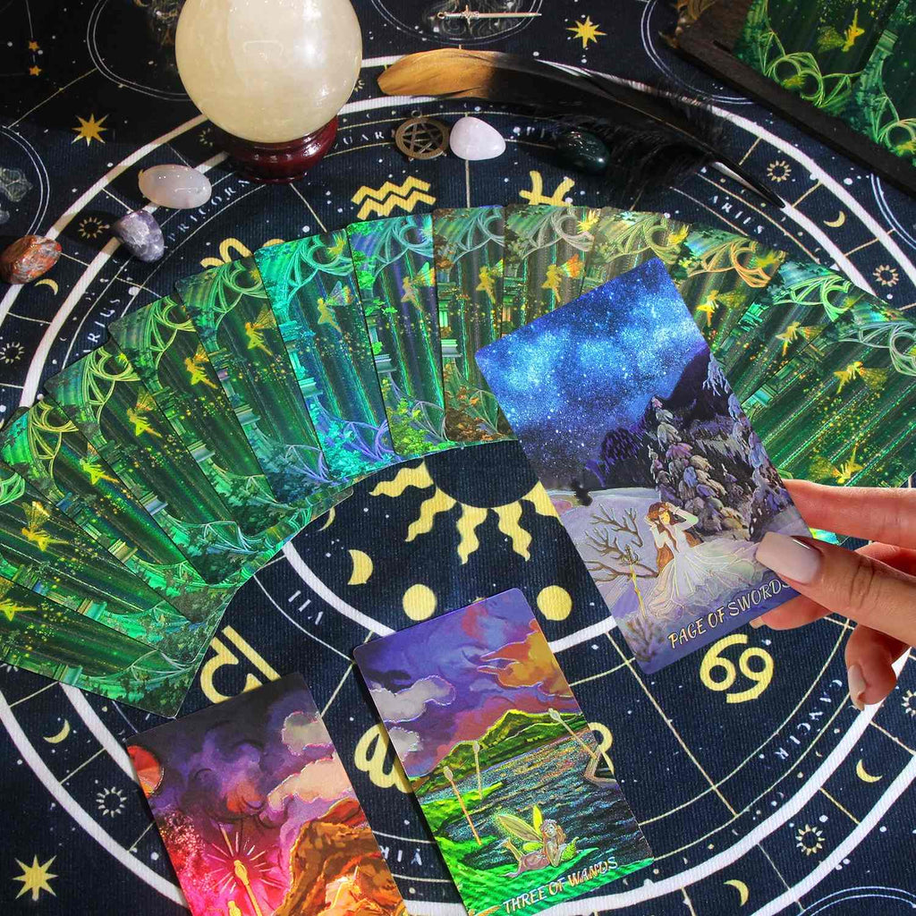 Colorful Laser Etched tarot cards on a tarot board with a hand holding a card.