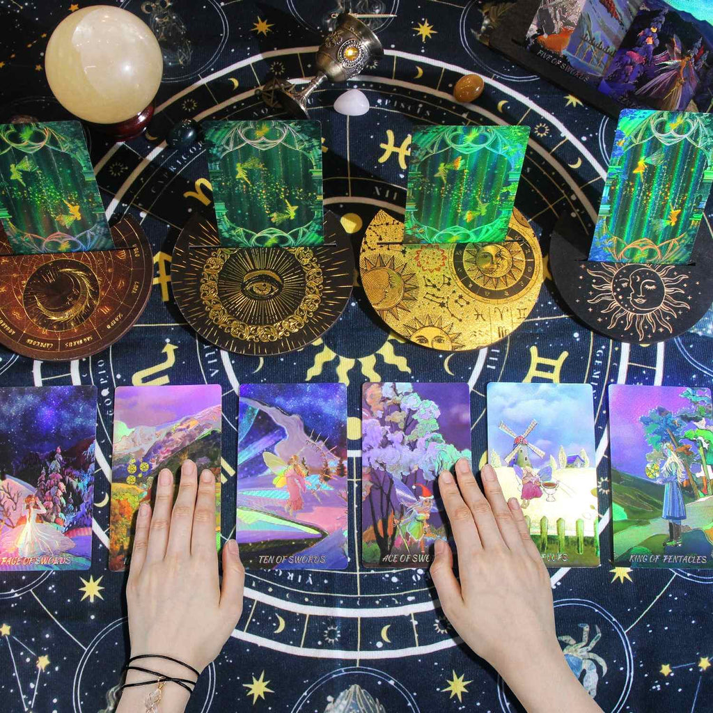 Colorful Laser Etched tarot cards on a starry night background with hands holding cards.