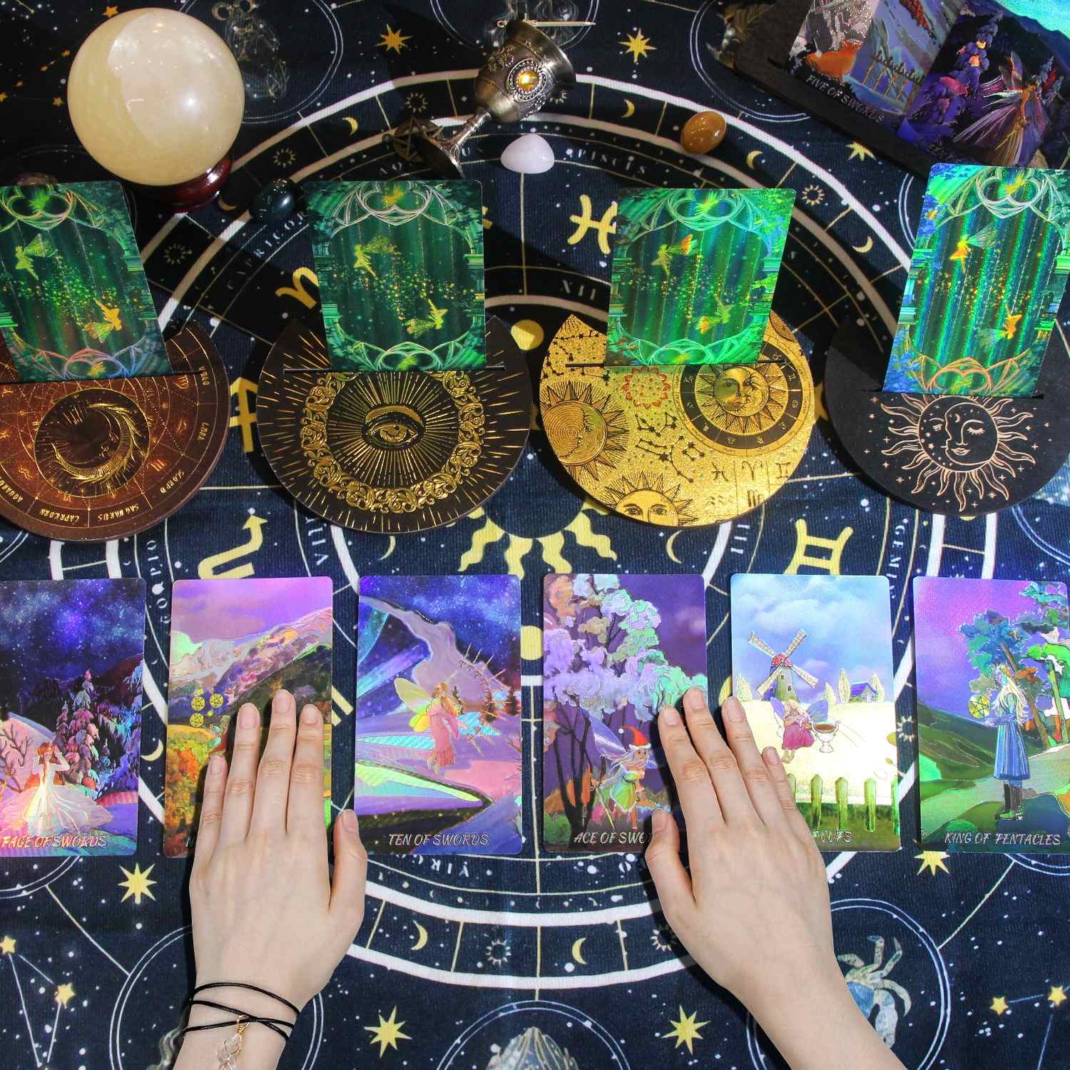 Colorful Laser Etched tarot cards on a starry night background with hands holding cards.