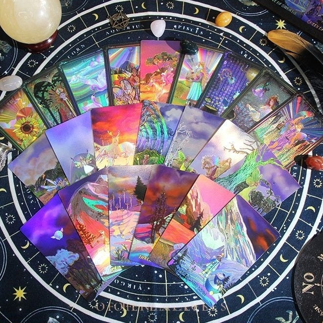Collection of colorful Laser Etched gold foil tarot cards on a astrological wheel