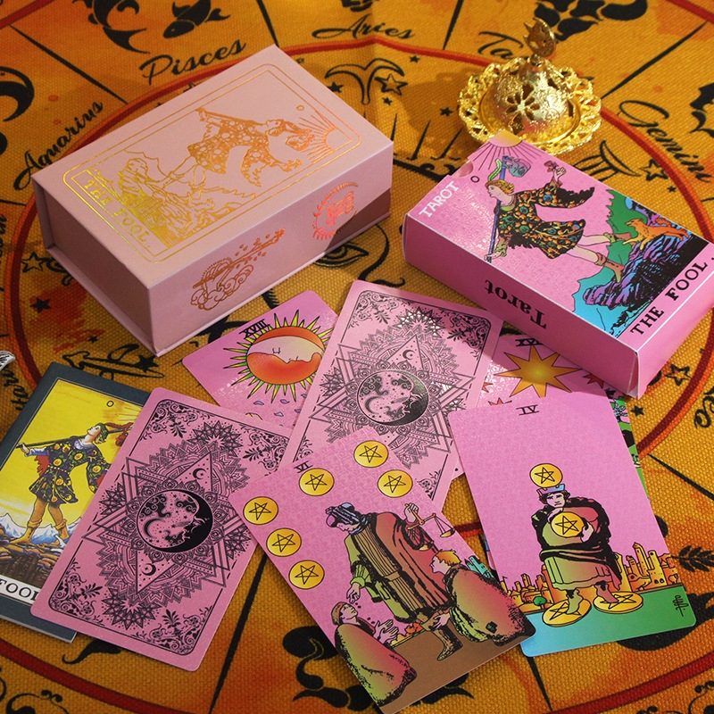 Pink tarot cards with colorful illustrations on a yellow astrological background