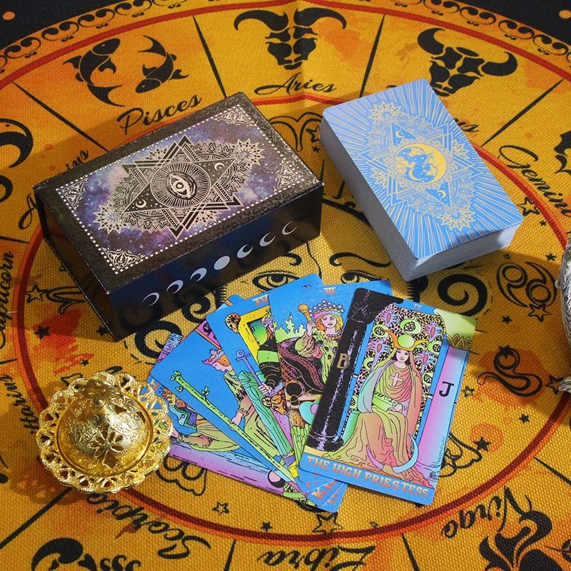 Tarot cards and boxes on a zodiac-themed surface