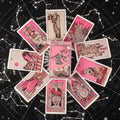 Collection of pink tarot cards on a starry night sky background