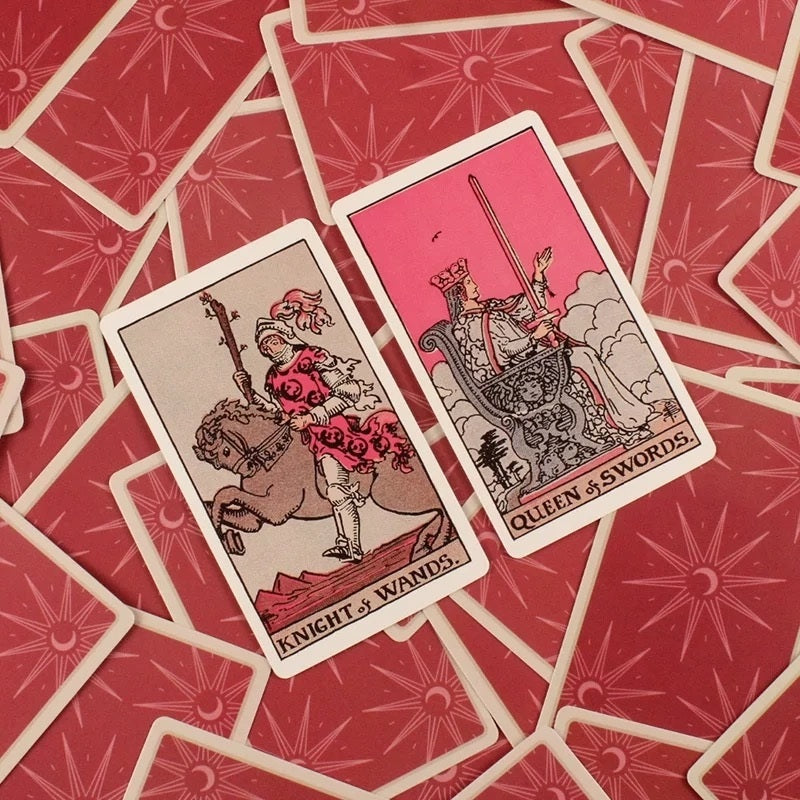 Two tarot cards, 'Knight of Wands' and 'Queen of Swords', on a red patterned background.