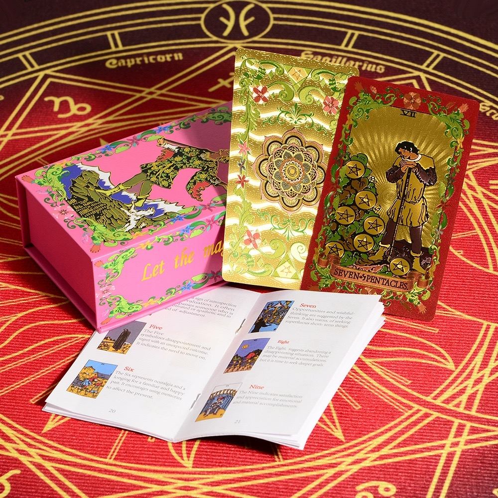 Pink & Gold Foil Mandala tarot card set with colorful packaging and instructions on a red and gold astrological background.