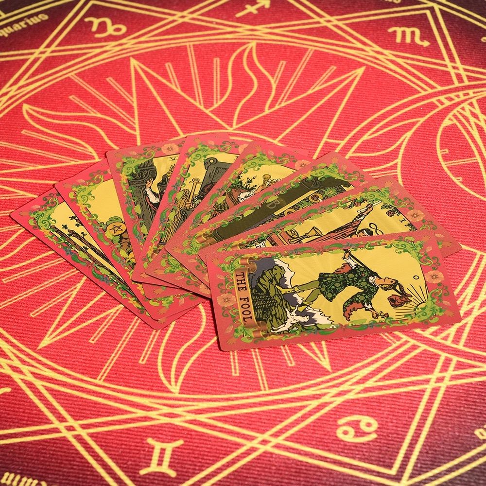 Pink & Gold Foil Mandala Tarot cards on a red and gold astrological design background