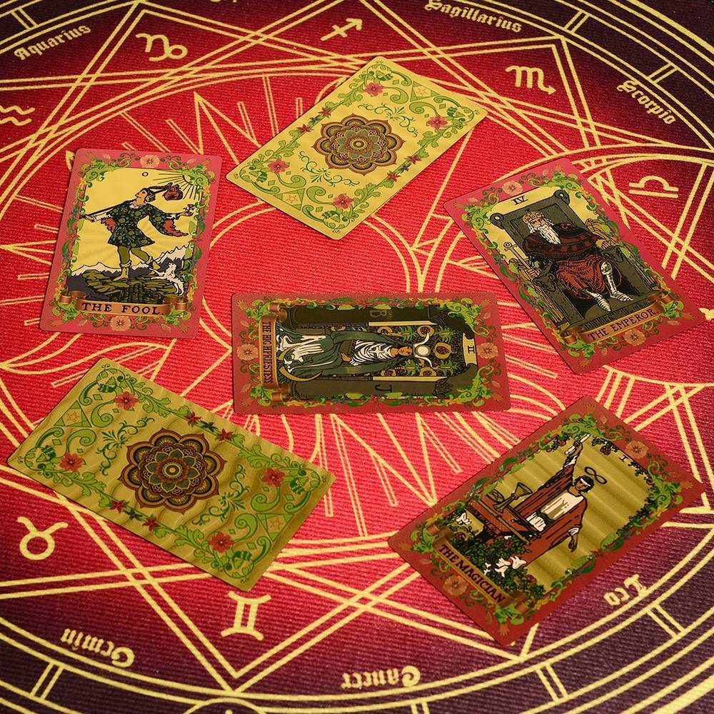 Set of Pink & Gold Foil Mandala tarot cards on a red and gold astrological symbol background
