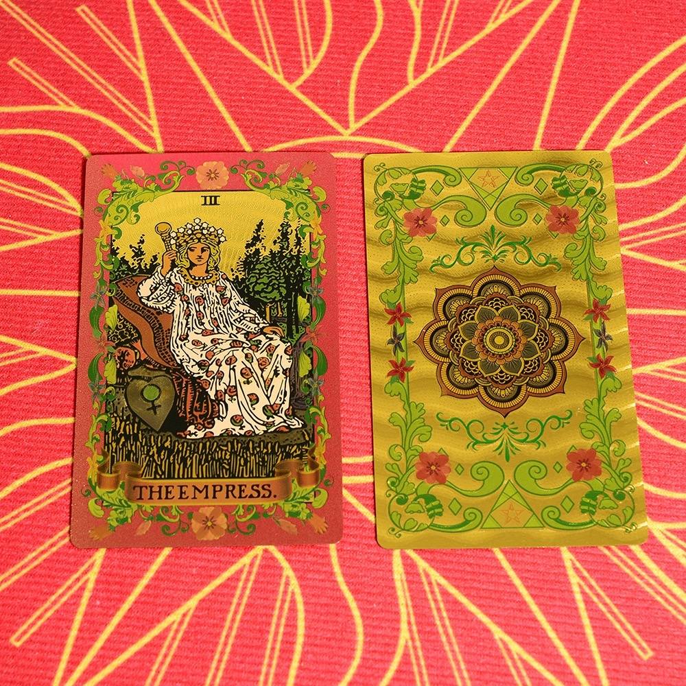 Two Pink & Gold Foil Mandala tarot cards on a pink and orange patterned background